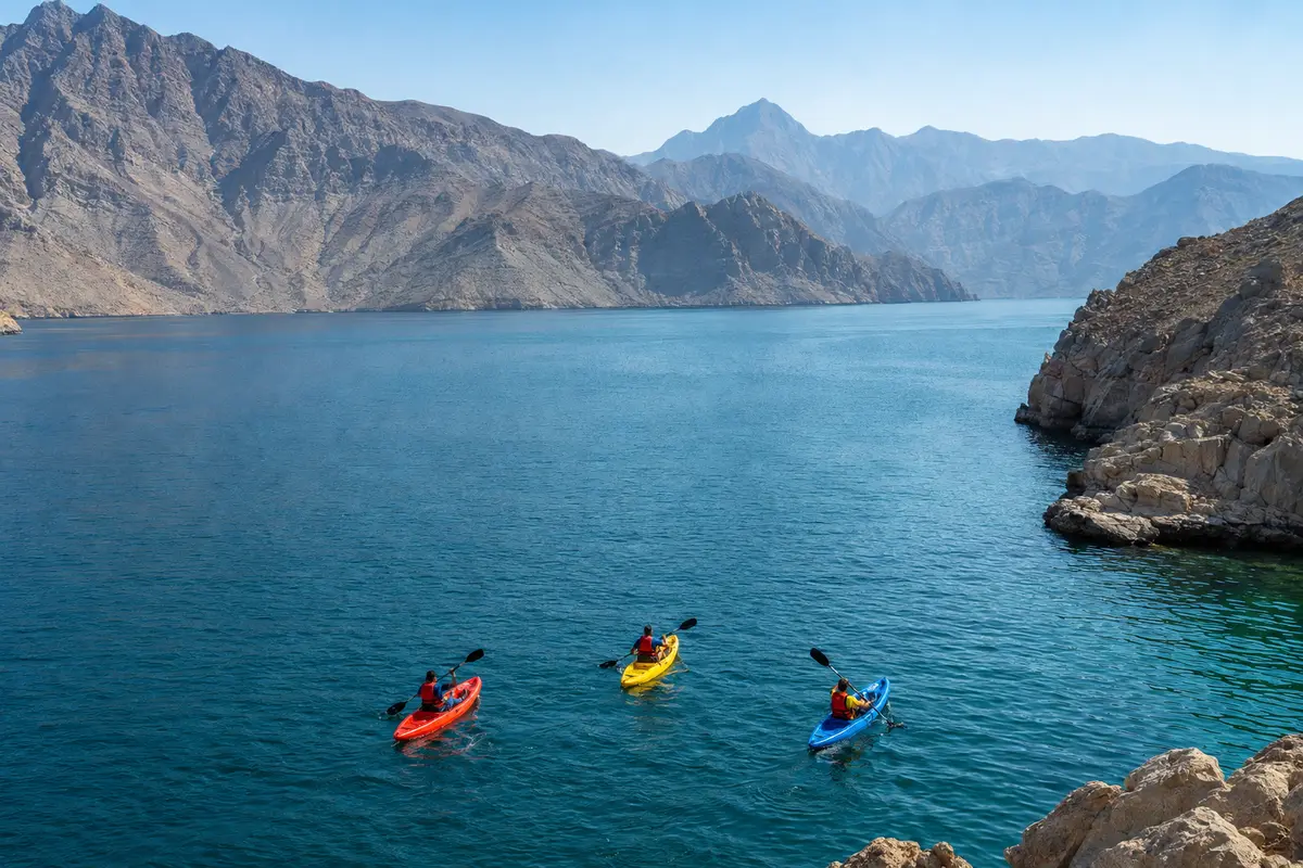 Guided kayaking group crossing the calm Al Khor fjord